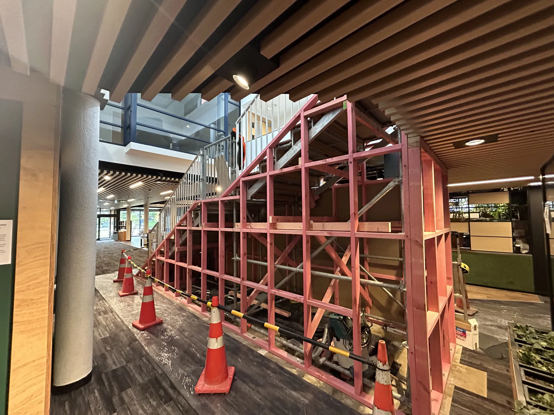 Exposed structural steel and temporary work area inside the George Forbes Building