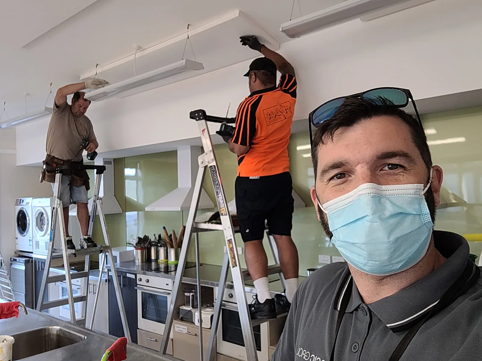 Josh Bohan coordinating contractors installing classroom acoustic panels
