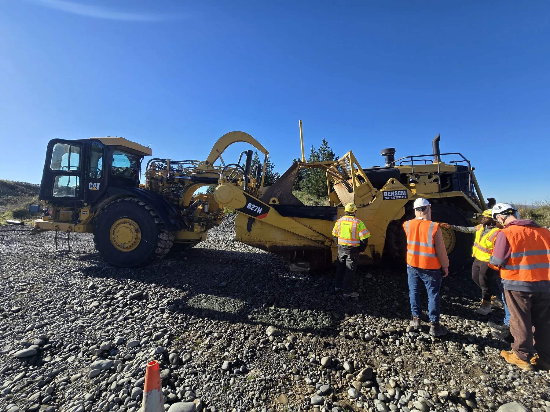 Team beside heavy construction machinery during a training day in Canterbury